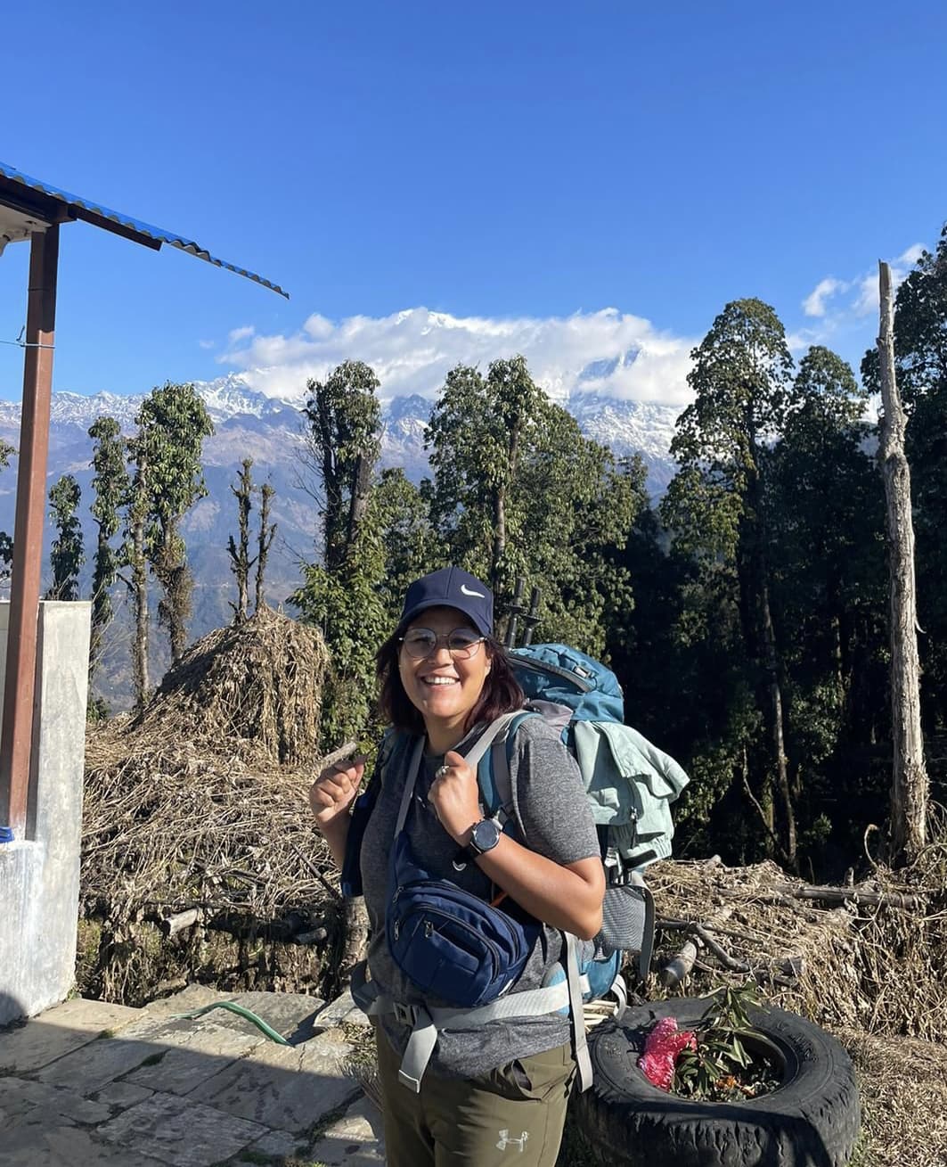 Profile photo of a trekking guide wearing a blue cap and sunglasses in the mountains